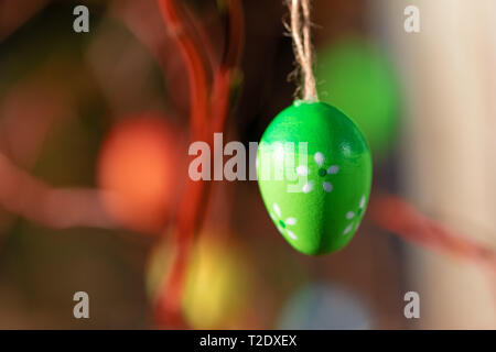 Hanging Easter eggs on tree with soft focus bokeh and color toned. Spring easter concept background. Stock Photo