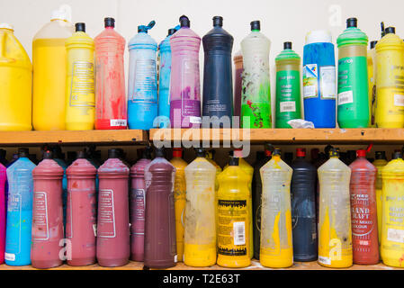 Poster Paint lined up on shelf in Classroom Stock Photo
