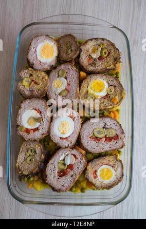 meat roll stuffed with egg, olives, ham and pepper Stock Photo