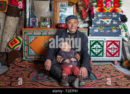 bayan Ulgii, Mongolia, 1st October 2015: mongolian nomad man with his granddaughter in their home Stock Photo