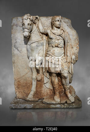 Roman Sebasteion relief sculpture of  an Imperial prince as Diokouros, Aphrodisias Museum, Aphrodisias, Turkey.  Against a grey background.  An imperi Stock Photo