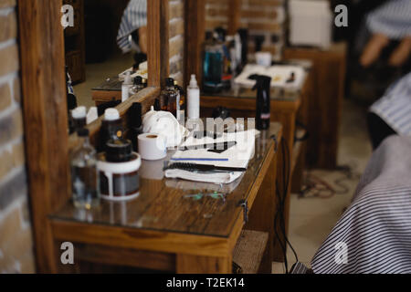 Vintage barber or shaver tools on wooden table in a barbershop - Shaving balm and foam Stock Photo