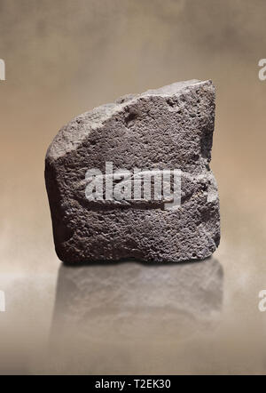 Fragment of a Late European Neolithic prehistoric Menhir standing stone with acarving of a horizontal knife on its face side.   Excavated from Montes  Stock Photo