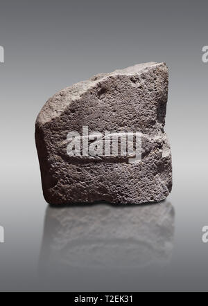 Fragment of a Late European Neolithic prehistoric Menhir standing stone with acarving of a horizontal knife on its face side.   Excavated from Montes  Stock Photo