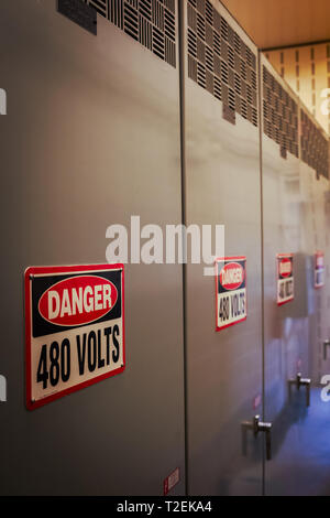 High Voltage Danger signs line the electrical cabinets of the George W. Kuhn wastewater treatment plant in Madison Heights, Michigan, USA Stock Photo