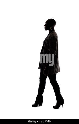 Black female African American model silhouette on a white background.  She is walking in side view Stock Photo