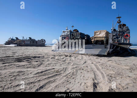 190330-N-NB544-1052 PACIFIC OCEAN (March 30, 2019) Landing craft air cushions, assigned to Assault Craft Unit (ACU) 5, prepare to unload vehicles and Marines assigned to the 11th Marine Expeditionary Unit (MEU). USS John P. Murtha (LPD 26) is underway conducting routine operations as a part of USS Boxer Amphibious Ready Group (ARG) in the eastern Pacific Ocean. (U.S. Navy photo by Mass Communication Specialist 2nd Class Kyle Carlstrom) Stock Photo