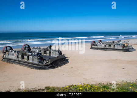 190330-N-NB544-1071 PACIFIC OCEAN (March 30, 2019) Landing craft air cushion (LCAC) 58, front, assigned to Assault Craft Unit (ACU) 5,  prepares to depart as LCAC 57 prepares to unload vehicles and Marines assigned to the 11th Marine Expeditionary Unit (MEU). John P. Murtha is underway conducting routine operations as a part of USS Boxer Amphibious Ready Group (ARG) in the eastern Pacific Ocean. (U.S. Navy photo by Mass Communication Specialist 2nd Class Kyle Carlstrom) Stock Photo