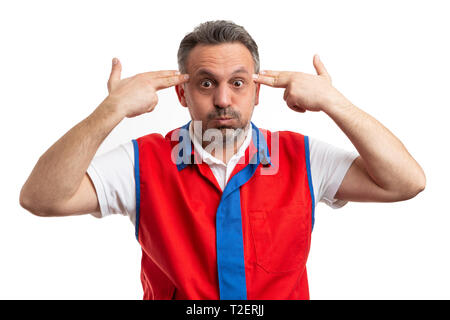 Joking male hypermarket or supermarket employee making pistol gun gesture with fingers on temples as shooting concept isolated on white background Stock Photo