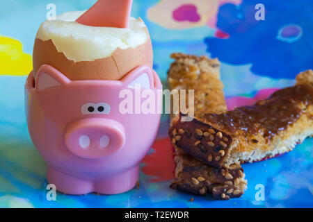 Boiled egg in egg cup with marmite on soldiers toast - breakfast concept Stock Photo