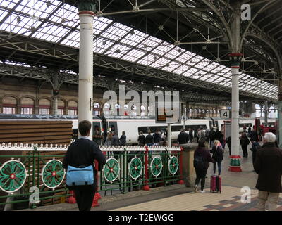 View of Preston railway station showing Victorian architecture, glazed roof and the ornate ironwork alongside the ramp down to the platforms Stock Photo