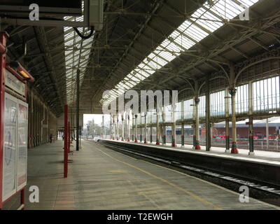 View of an empty platform at Preston railway station showing the Victorian architecture and glazed roof. Stock Photo