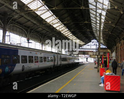 View of Preston railway station showing Victorian architecture, glazed roof, platforms and trains. Stock Photo