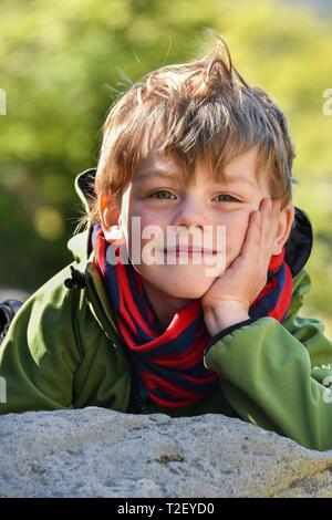 Portrait of a little boy, head resting on stone, Argentina Stock Photo