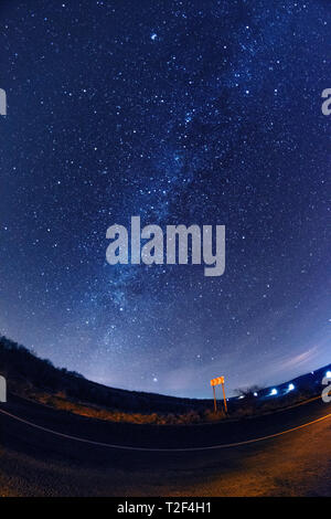 Beautiful Milky Way galaxy long exposure shot starry sky during night on the road side Stock Photo