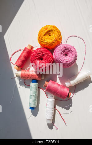 Flat lay composition with sewing threads on color background Stock Photo