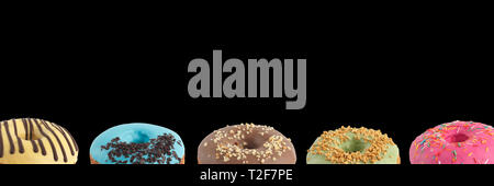 Appetizing donuts with multi-colored icing on a black background. Isolated Close-up. Banner. Stock Photo