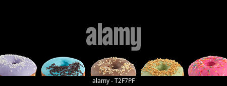 Appetizing donuts with multi-colored icing on a black background. Isolated Close-up. Banner. Stock Photo