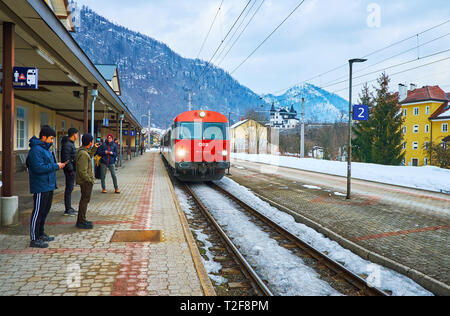 BAD ISCHL, AUSTRIA - FEBRUARY 21, 2019: The modern red train arrives to the Bad Ischl Railway station (Bahnhof), on February 21 in Bad Ischl. Stock Photo