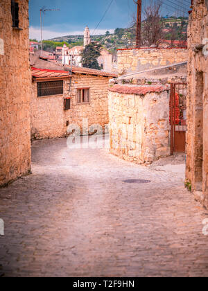 Old stone houses on a narrow streets in the picturesque medieval city of Lofou. Limassol District, Cyprus Stock Photo