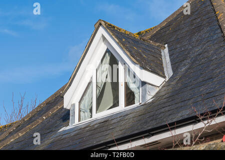 Dormer window protruding from a roof in the UK. Loft window. Stock Photo