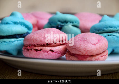 Blue and pink french macarons with blueberry and raspberry filling - perfect for the baby shower Stock Photo