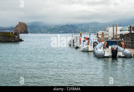 MADALENA, PORTUGAL - MAY 03, 2012: Inflatable motor boats moored at the pier of the city of Madalena. Tourist transport between the islands of Pico an Stock Photo