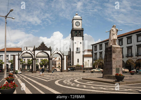 PONTA DELGADA, PORTUGAL - MAY 10, 2012: People in main square of city, near historic City Gates (Portas da Cidade) and the St. Sebastian Church, Sao M Stock Photo