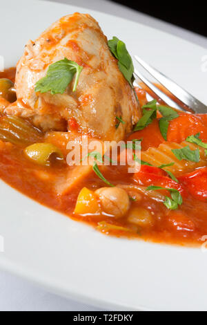 A plated dish of Spanish Chicken, Red pepper and olive stew Stock Photo