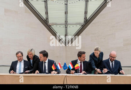 02 April 2019, Luxemburg: Armin Laschet (CDU, l-r), Prime Minister of North Rhine-Westphalia, Mark Rutte, Prime Minister of the Netherlands, Xavier Bettel, Prime Minister of Luxembourg and Charles Michel, Prime Minister of Belgium, are sitting at the same table to sign the treaty together. The Benelux states and North Rhine-Westphalia want to intensify their cooperation. Photo: Bernd Thissen/dpa Stock Photo