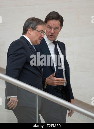 02 April 2019, Luxemburg: Armin Laschet (CDU, l), Prime Minister of North Rhine-Westphalia, and Mark Rutte, Prime Minister of the Netherlands, come downstairs to sign the treaty together. The Benelux states and North Rhine-Westphalia want to intensify their cooperation. Photo: Bernd Thissen/dpa Stock Photo