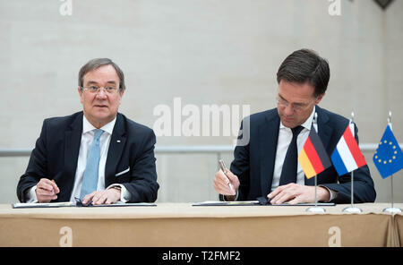 02 April 2019, Luxemburg: Armin Laschet (CDU, l), Prime Minister of North Rhine-Westphalia, and Mark Rutte, Prime Minister of the Netherlands, are sitting at the same table to sign the treaty together. The Benelux states and North Rhine-Westphalia want to intensify their cooperation. Photo: Bernd Thissen/dpa Stock Photo