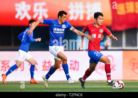 Zhengzhou, China. 31st Mar, 2019. Colombian football player Giovanni Moreno, left, of Shanghai Greenland Shenhua challenges a player of Henan Jianye in their 3rd round match during the 2019 Chinese Football Association Super League (CSL) in Zhengzhou city, central China's Henan province, 31 March 2019. Shanghai Greenland Shenhua defeated Henan Jianye 2-1. Credit: Matt Buxton/Alamy Live News
