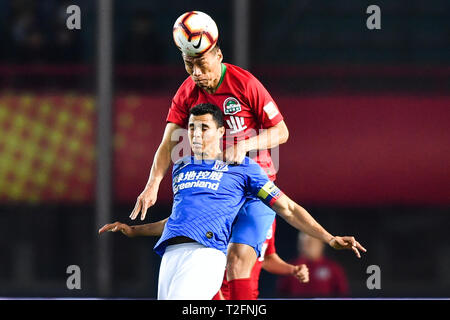 Zhengzhou, China. 31st Mar, 2019. A player of Henan Jianye challenges Colombian football player Giovanni Moreno, bottom, of Shanghai Greenland Shenhua in their 3rd round match during the 2019 Chinese Football Association Super League (CSL) in Zhengzhou city, central China's Henan province, 31 March 2019. Shanghai Greenland Shenhua defeated Henan Jianye 2-1. Credit: Matt Buxton/Alamy Live News