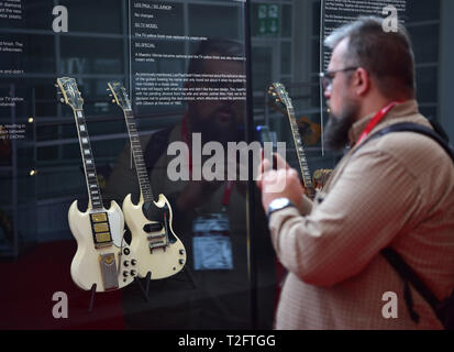 Frankfurt, Germany. 2nd Apr, 2019. A man takes photos of vintage guitars exhibited by Gibson at the Musikmesse in Frankfurt, Germany, on April 2, 2019. The four-day event Musikmesse, Europe's leading trade fair for the music industry, kicked off here on Tuesday. Credit: Lu Yang/Xinhua/Alamy Live News Stock Photo