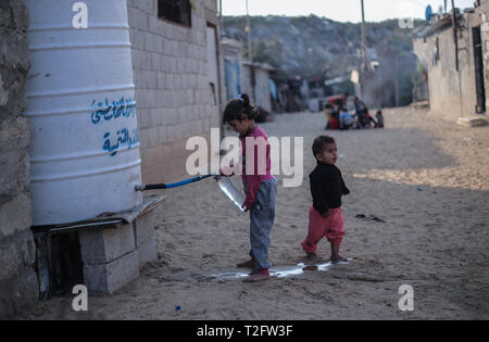 Gaza, khan younis, Palestine. 2nd Apr, 2019. Palestinian kid seen getting water from a tank tap source.The population of Gaza facing a drinking water problem is increasing, highlighting the humanitarian issues facing the Palestinian generation in the besieged Gaza Strip for several years, which the United Nations says could become uninhabitable by 2020. Credit: Yousef Masoud/SOPA Images/ZUMA Wire/Alamy Live News Stock Photo