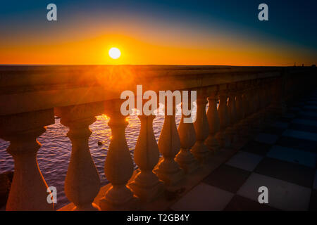 Abstract patterns in singular terrace Mascagni in Livorno, Italy. Balustrade against stunning sunset with long shadows. Stock Photo