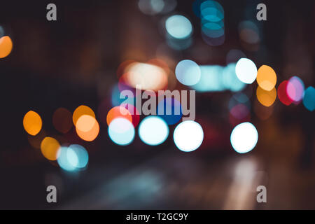 Abstract bokeh lights in city blurred night background Stock Photo
