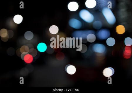 Abstract bokeh lights in city blurred night background Stock Photo