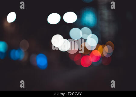 Abstract bokeh lights in city blurred night background Stock Photo