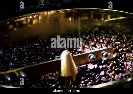 Roasted coffee in coffee roaster, Machine for roasting coffee close up, bean roasting Stock Photo