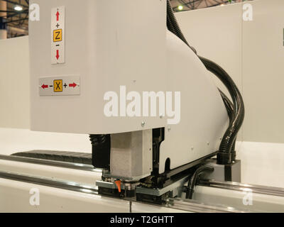 automated industrial programmable laser cutting engraving machine. closeup side view image inside manufacture facility Stock Photo