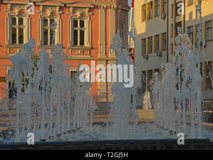 Jet of water spraying and splashing from a fountain Stock Photo