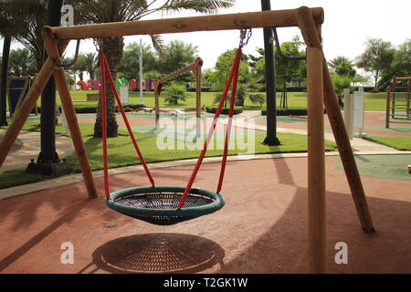 A Modern Design for Swing Set with a Bowl for Children to play in Clean and tidy Public Park in KAEC Stock Photo