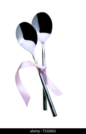 Two spoons tied together with pink ribbon. On a white background. Stock Photo