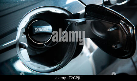 Diesel car concept. Open car fuel tank cap with the word diesel. Stock Photo
