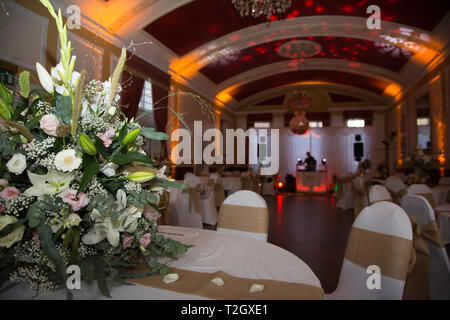 Wedding Reception room, all lit up ready for the first dance, with pretty lights, large room with a dome shaped roof,ready for the wedding celebration Stock Photo