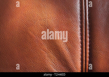 Genuine leather with seam, brown background texture, close up Stock Photo