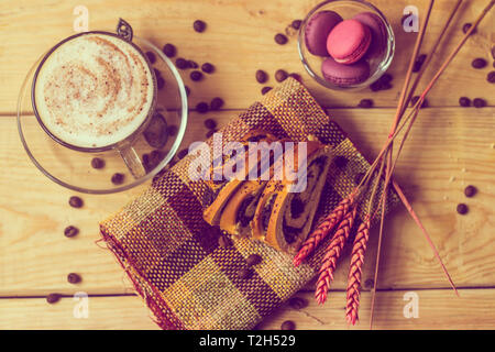 Macaroni cakes, coffee grains, sprigs of millet. Macaroni Cakes on wooden background. Stock Photo