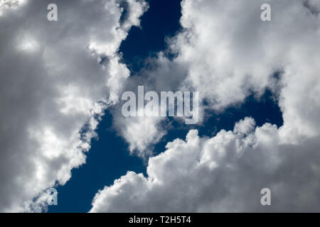 blue sky between sunlit clouds Stock Photo